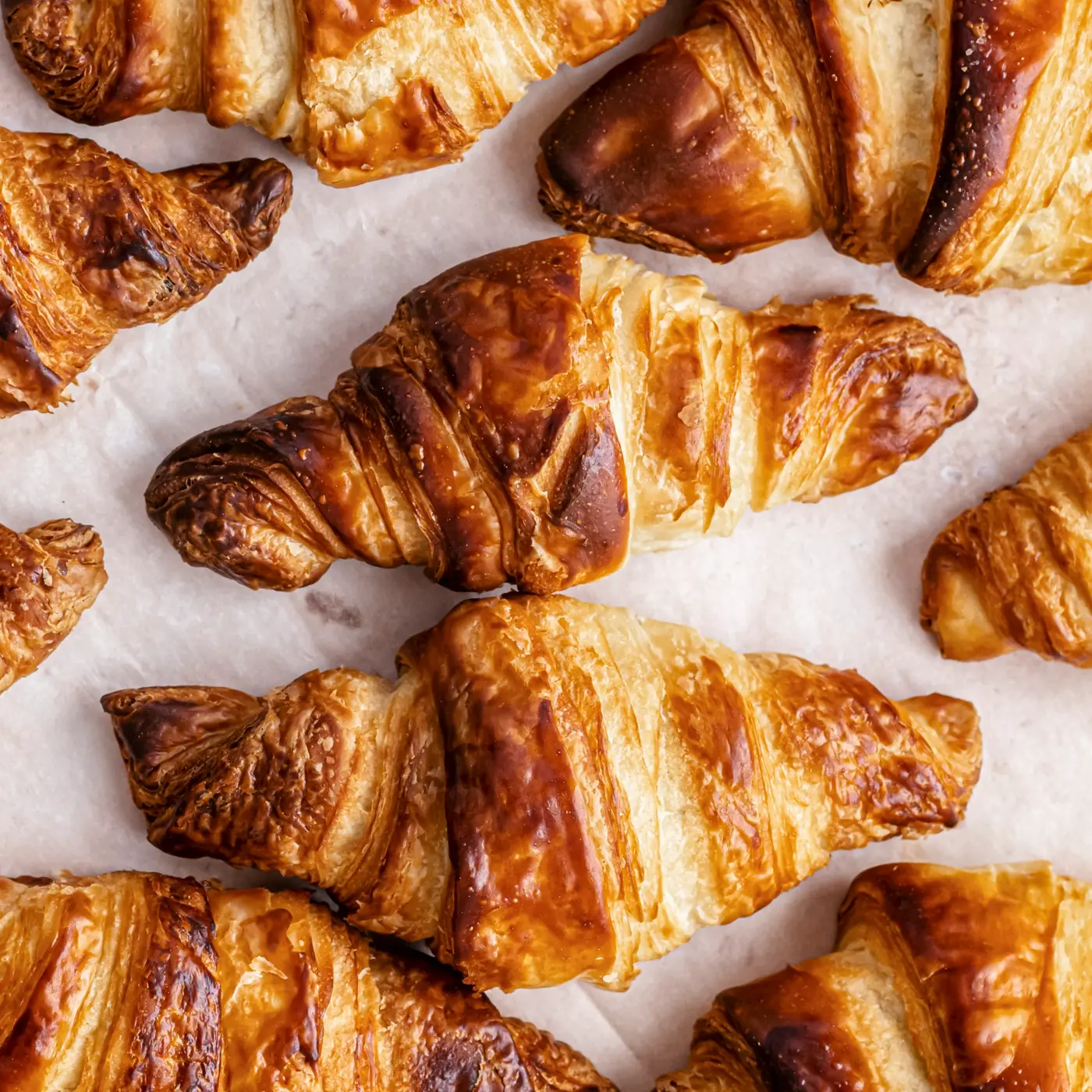 Freshly baked golden croissants with flaky layers at Creperie Antoinette